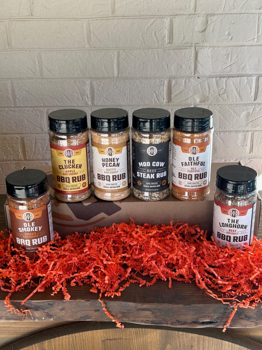 Six Grill Master barbecue rub bottles displayed around the gift box