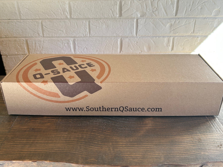 Closed kraft Grill Master rub gift box with Q Sauce logo