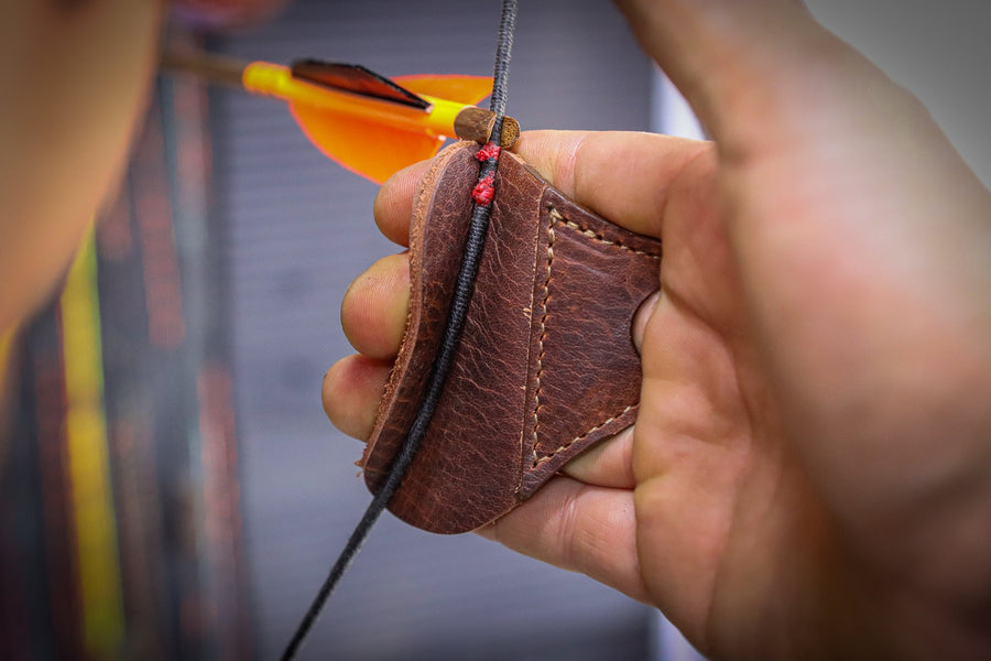 YES Tab 3-Under Archery Finger Tab — side view of tab against fingers and string