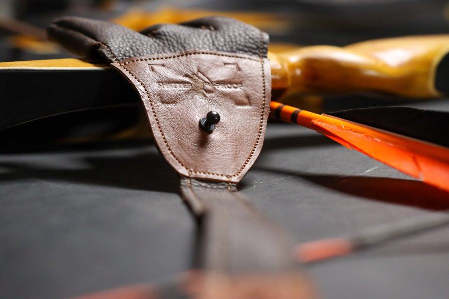 Leather Archery Shooting Glove — glove shown with arrows and bow