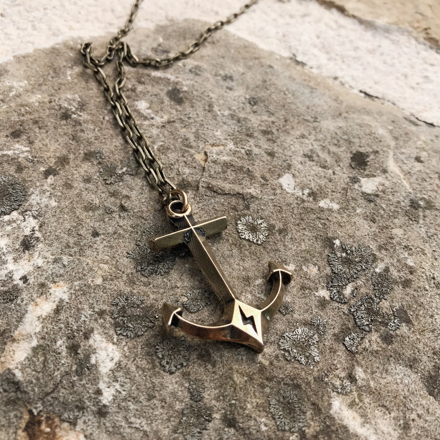 Anchor pendant resting against textured stone