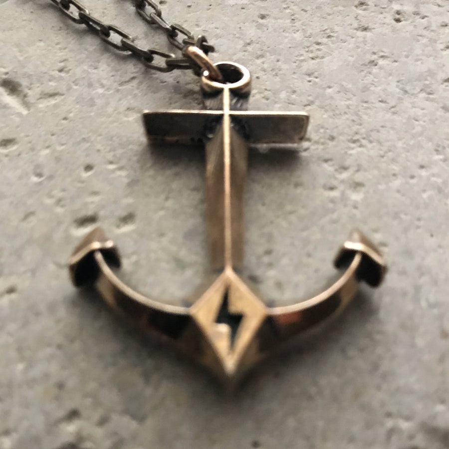 Hold Fast Anchor pendant against pale stone