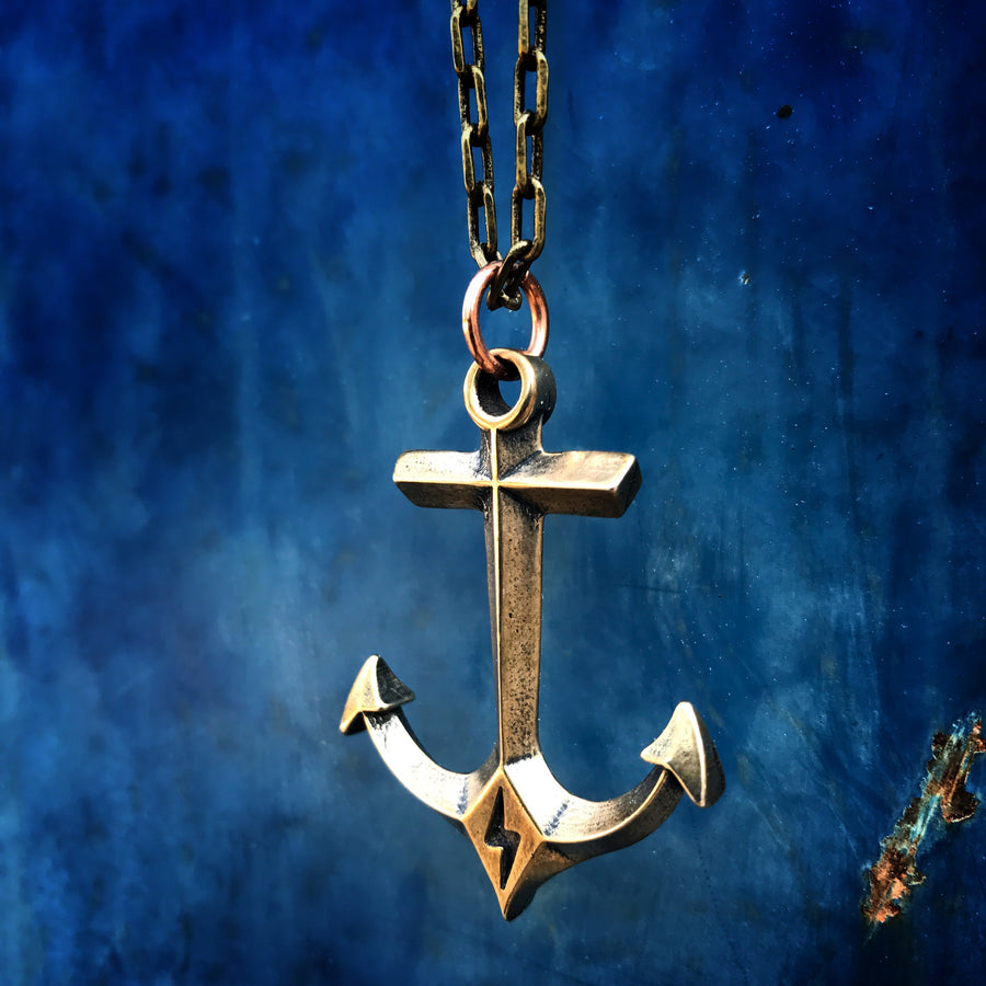 Close view of the anchor pendant against a blue background