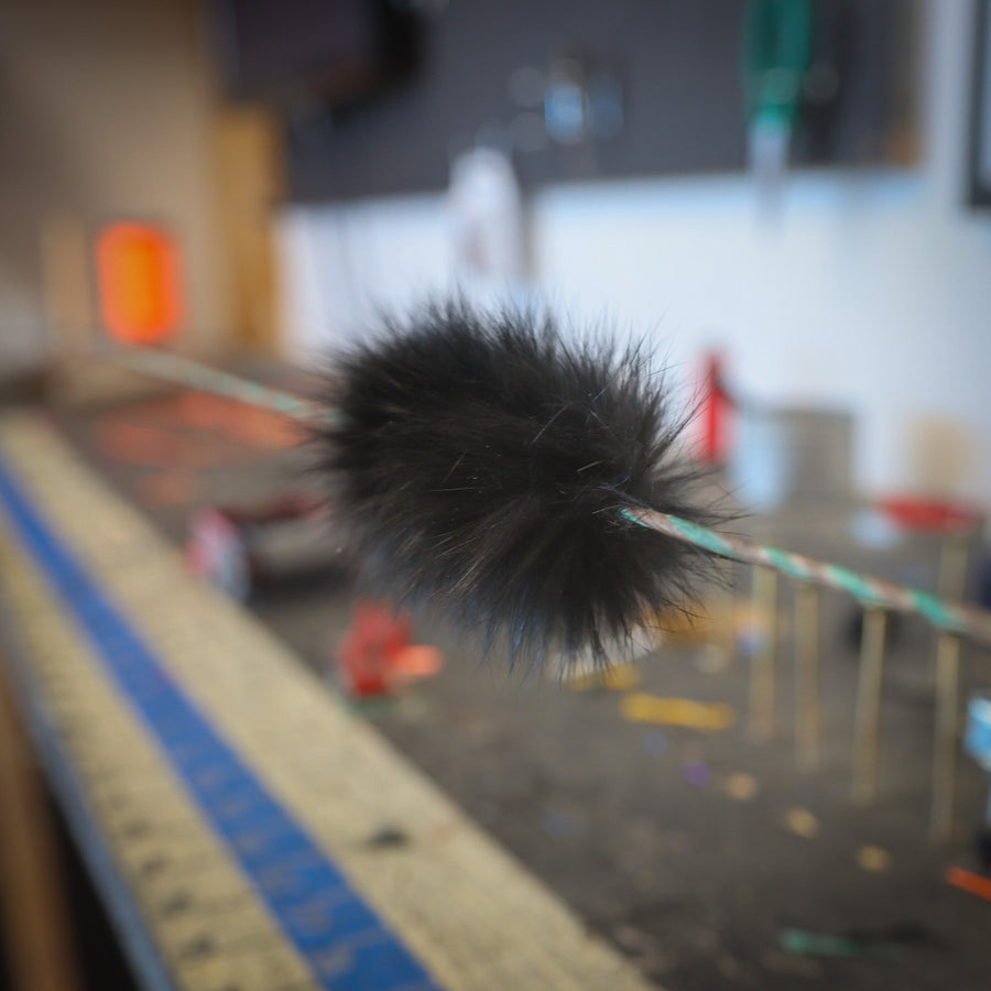 Black Rabbit Fur Bowstring Silencers — rabbit-fur silencer installed on a string