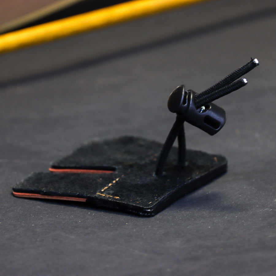 Shell Cordovan Split-Finger Archery Tab — edge view of cord and leather layers