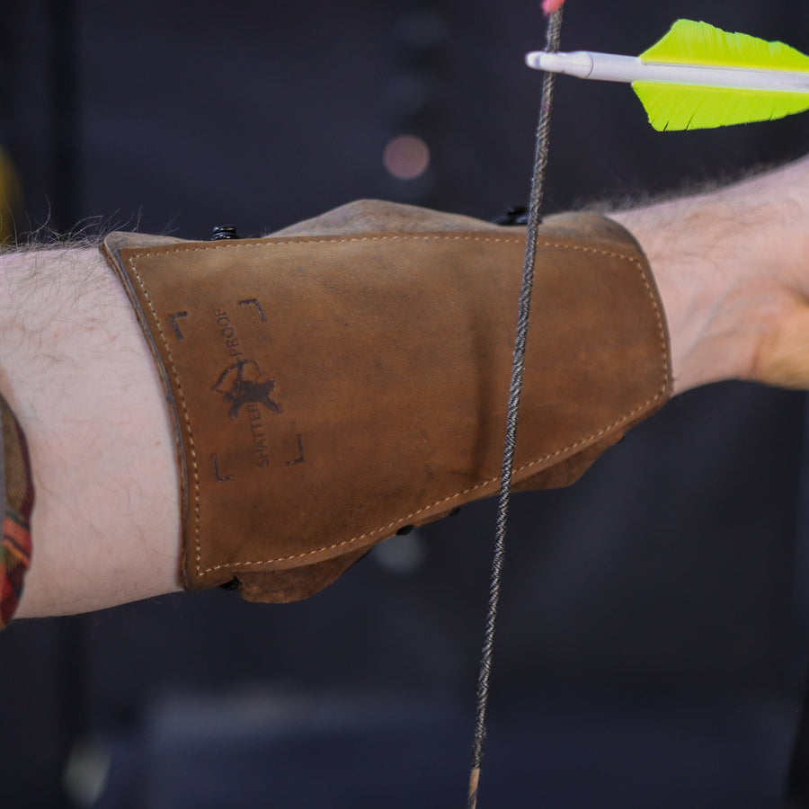 Ultimate Leather Archery Armguard — guard covering forearm beside arrow