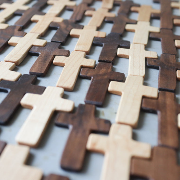 Thin wooden pocket crosses in varied natural wood tones.