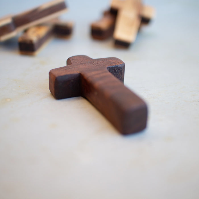 Handmade wooden pocket crosses in varied reclaimed wood colors.