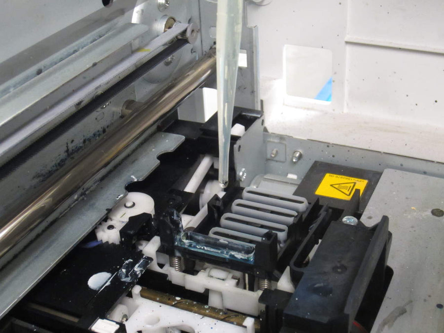 Interior maintenance area of a garment printer shown with the F2000 tube wash listing