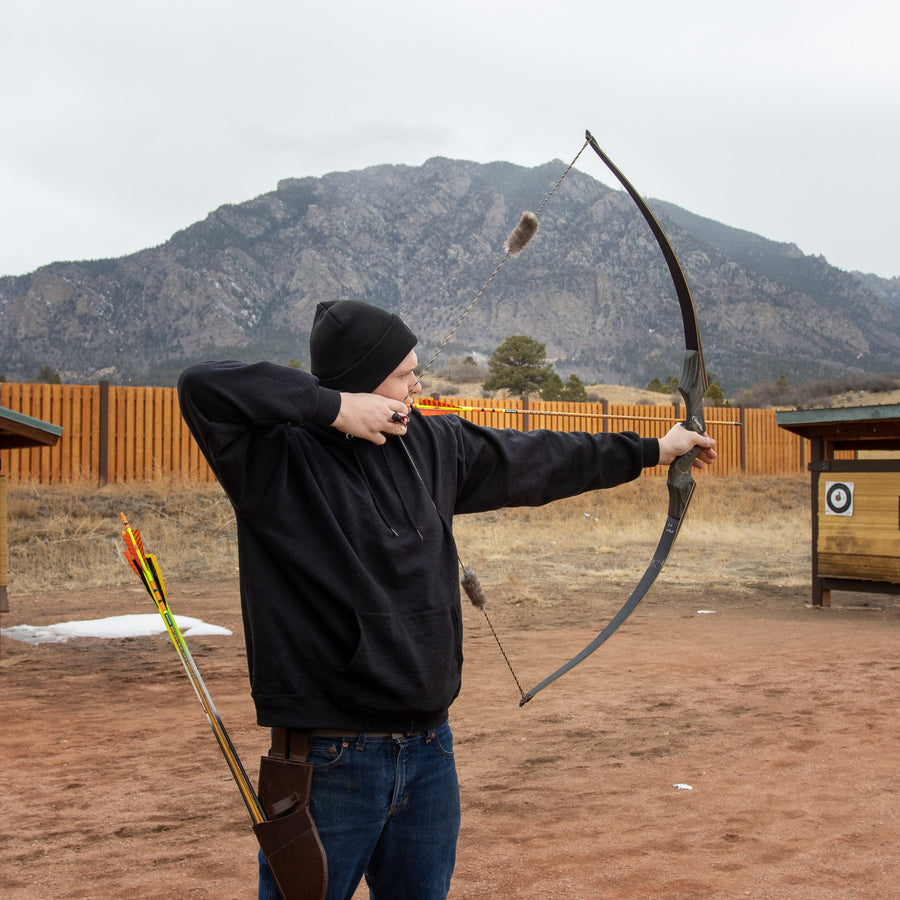 Beaver Fur Bowstring Silencers — archer demonstrating traditional bow outdoors