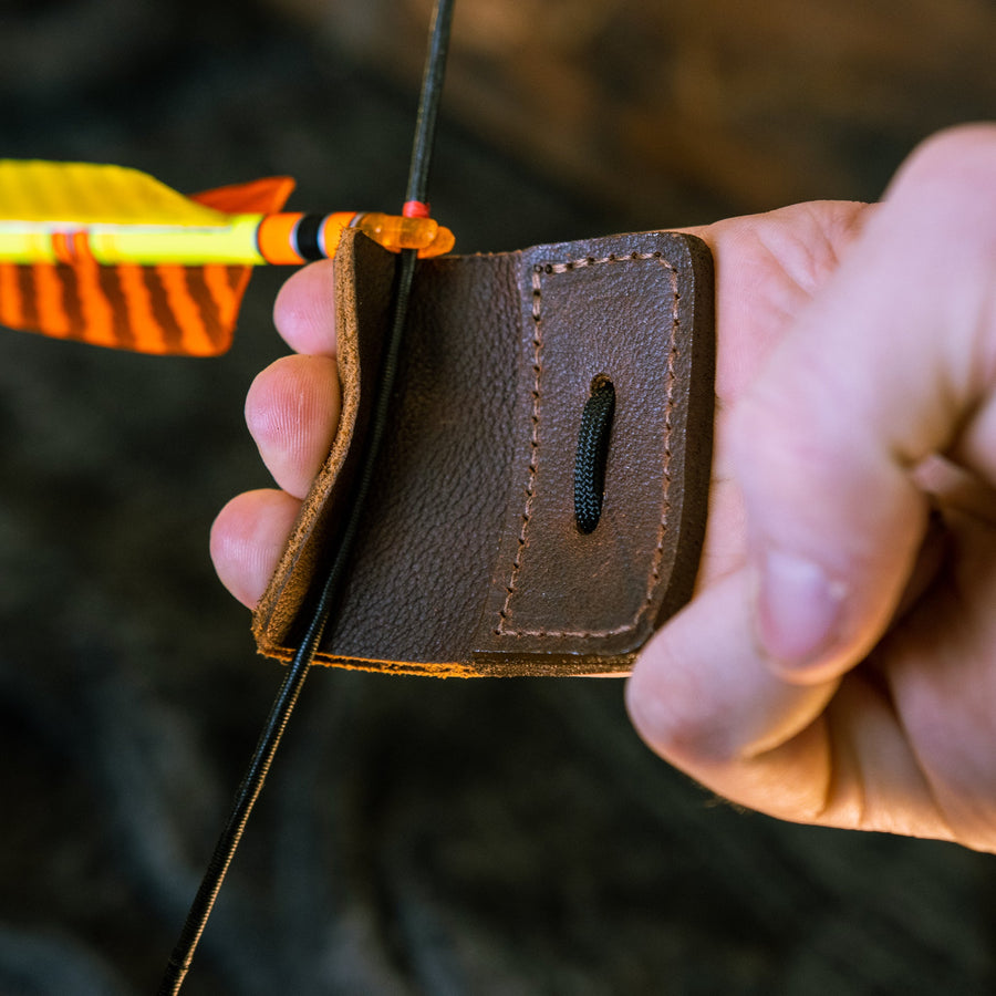 3-Under Leather Archery Tab — three-under tab worn with bowstring