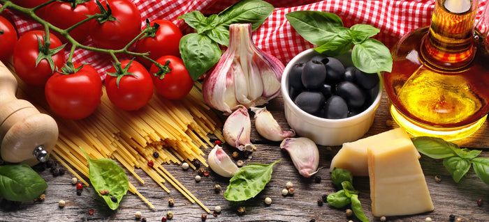 Pasta, tomatoes, garlic, olives, and olive oil illustrating Italian-style cooking