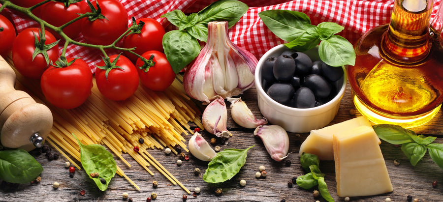 Pasta, tomatoes, garlic, olives, and olive oil illustrating Italian-style cooking