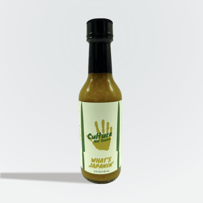 What’s Japanin’ citrus hot sauce bottle with a yellow-green handprint label