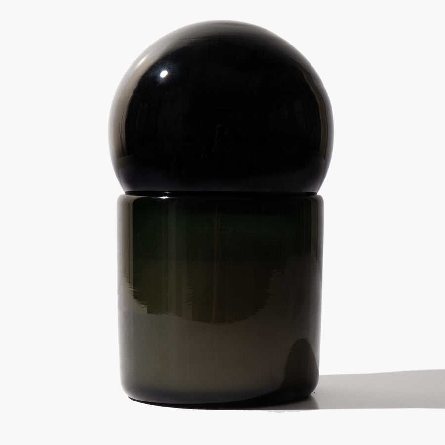 Orb of Divinity candle with dark spherical glass lid in place