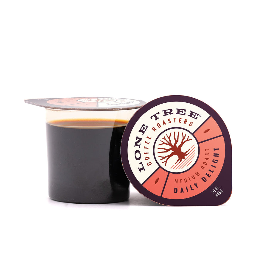 Open Daily Delight pod beside lid