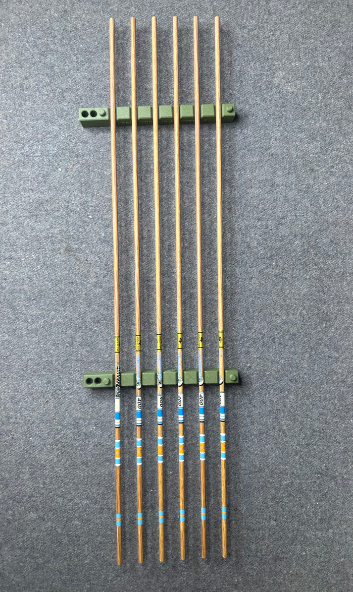 Arrows supported on green cresting rests during bench work
