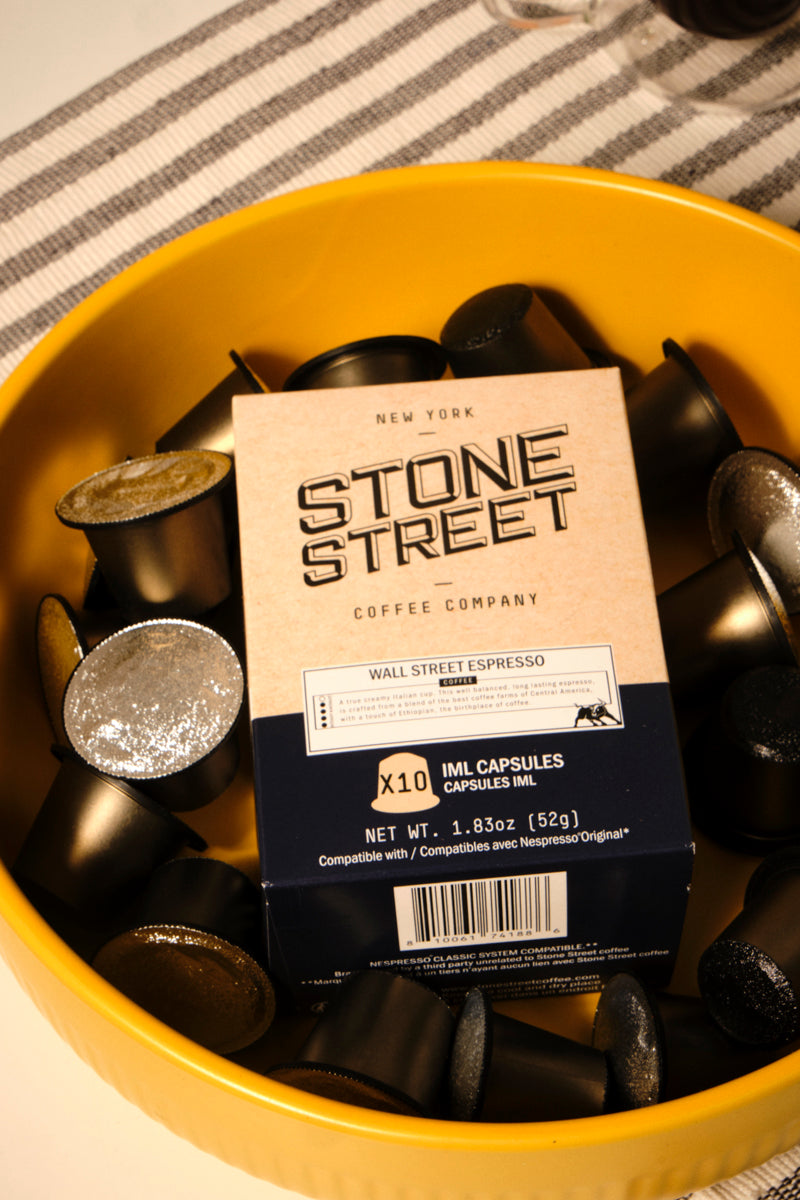 Wall Street Espresso capsule box pictured with individual capsules in a bowl