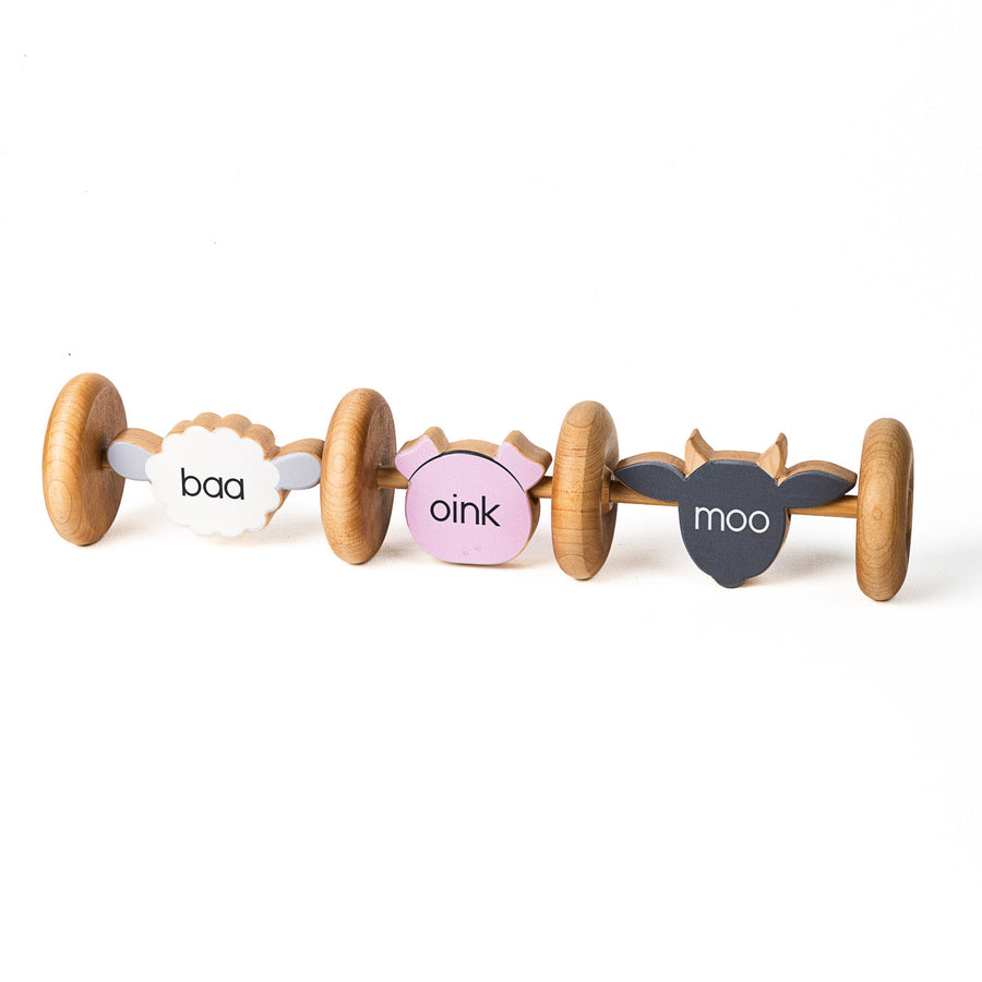 Linked wooden farm animal rolling toy with cow, pig and sheep designs