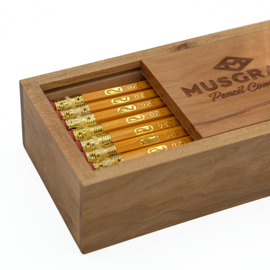 Close-up of the open cherry box and pencils with banded ferrules
