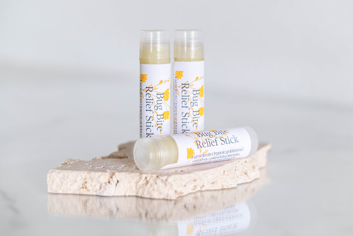 Botanical skin balm sticks arranged on a stand