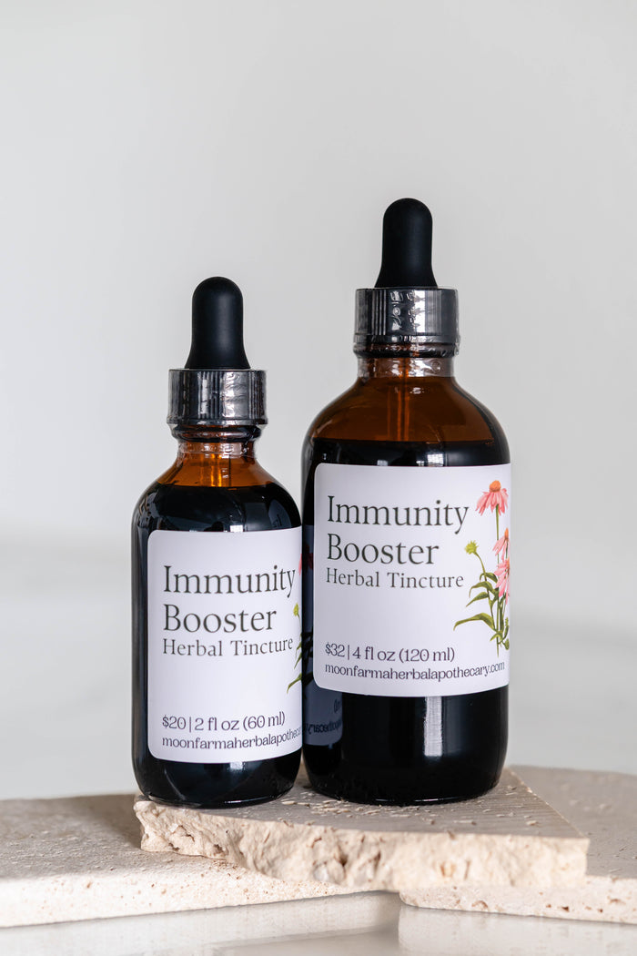 Two amber dropper bottles of nettle and elderberry herbal tincture
