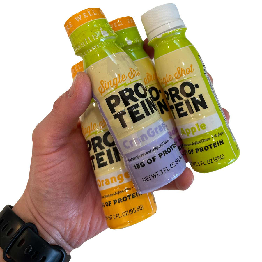 Protein & Collagen Shots: hand holding three protein shot bottles.