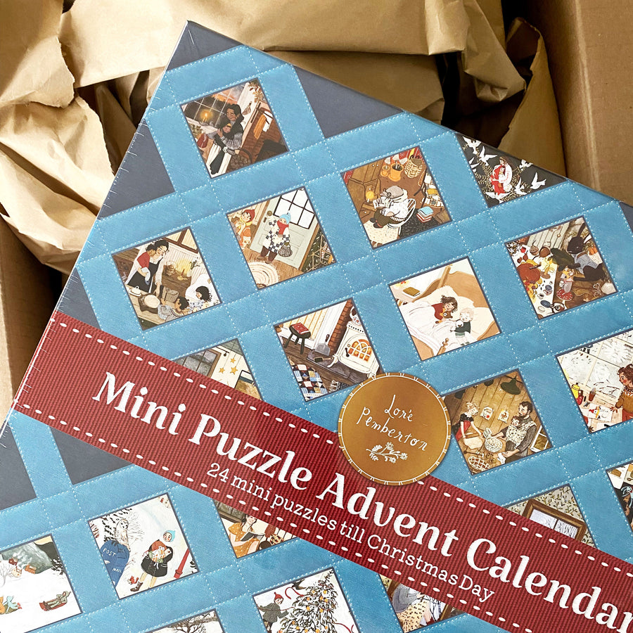 Stacked Loré Pemberton advent calendar mini puzzle boxes