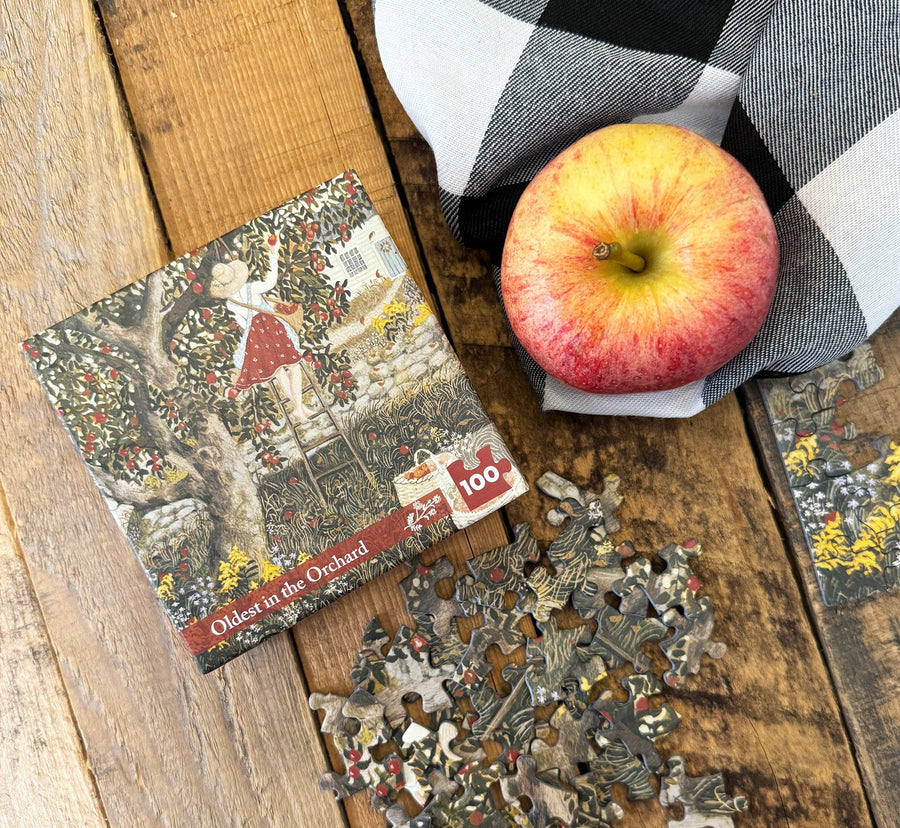 Oldest Orchard Mini puzzle box styled beside an apple