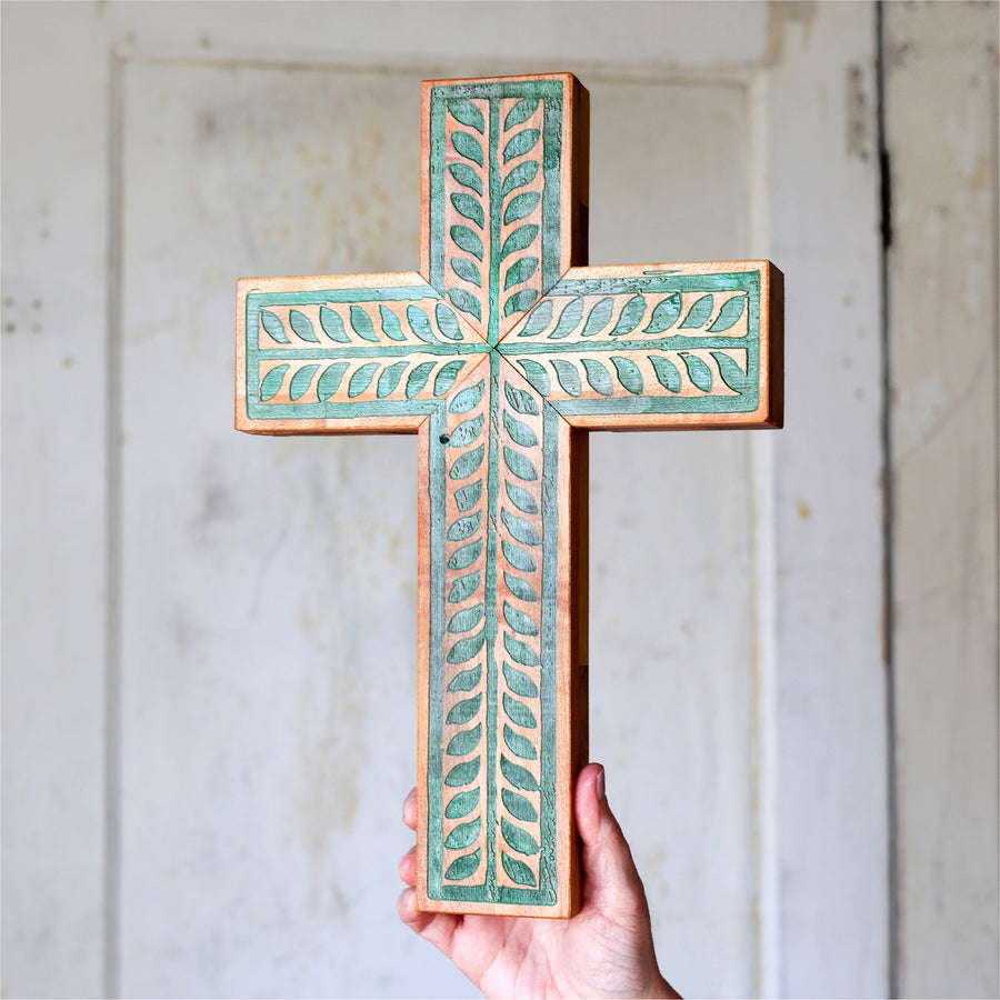 Piano wood cross engraved and painted with a turquoise vine illustration.