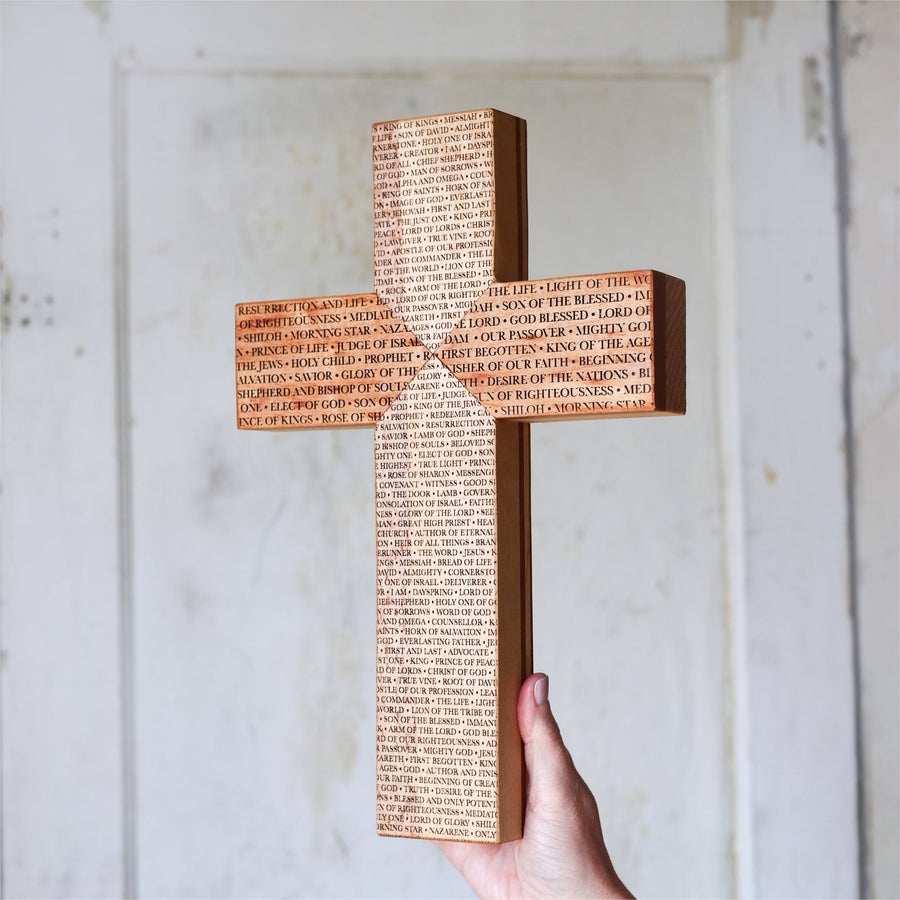 Reclaimed piano wood cross engraved with names of the Savior.