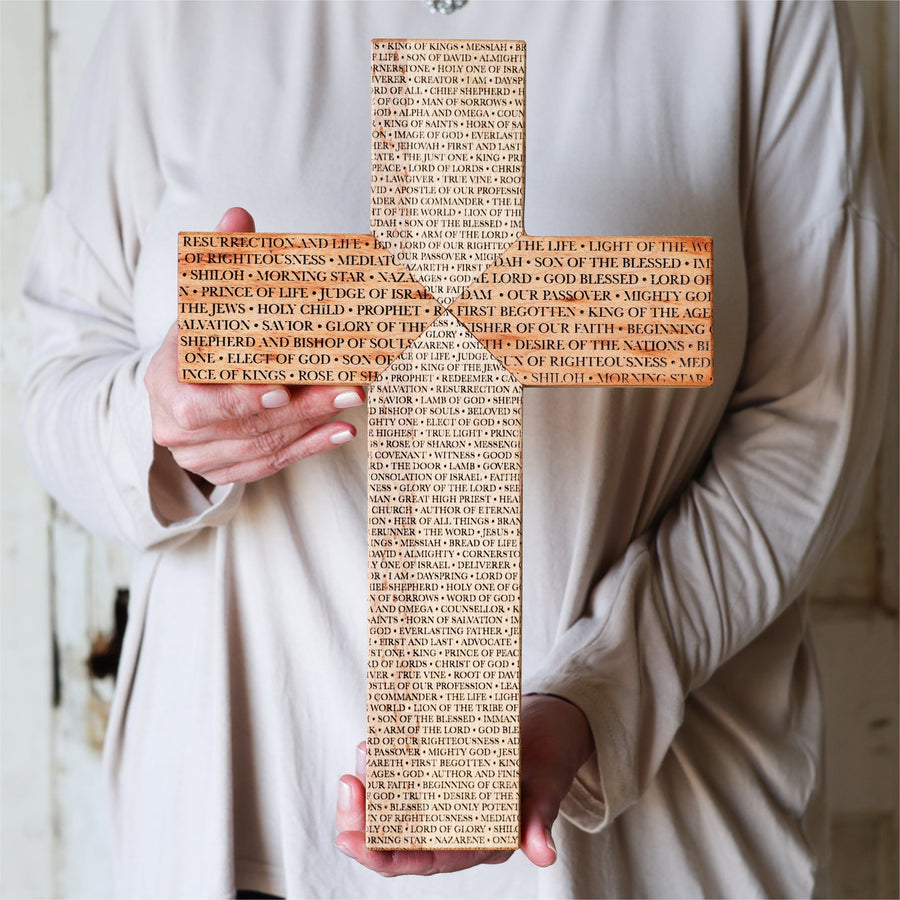 Reclaimed piano wood cross engraved with names of the Savior.