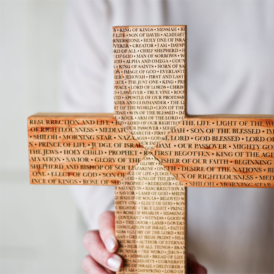 Reclaimed piano wood cross engraved with names of the Savior.