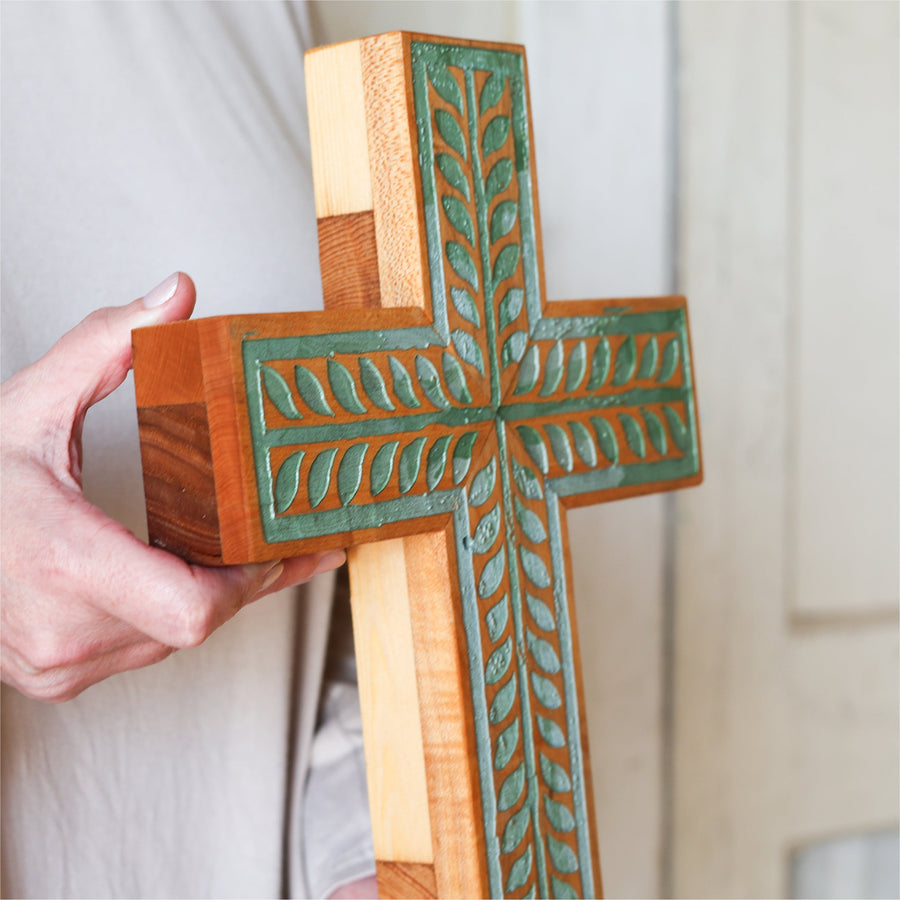 Piano wood cross engraved and painted with a turquoise vine illustration.