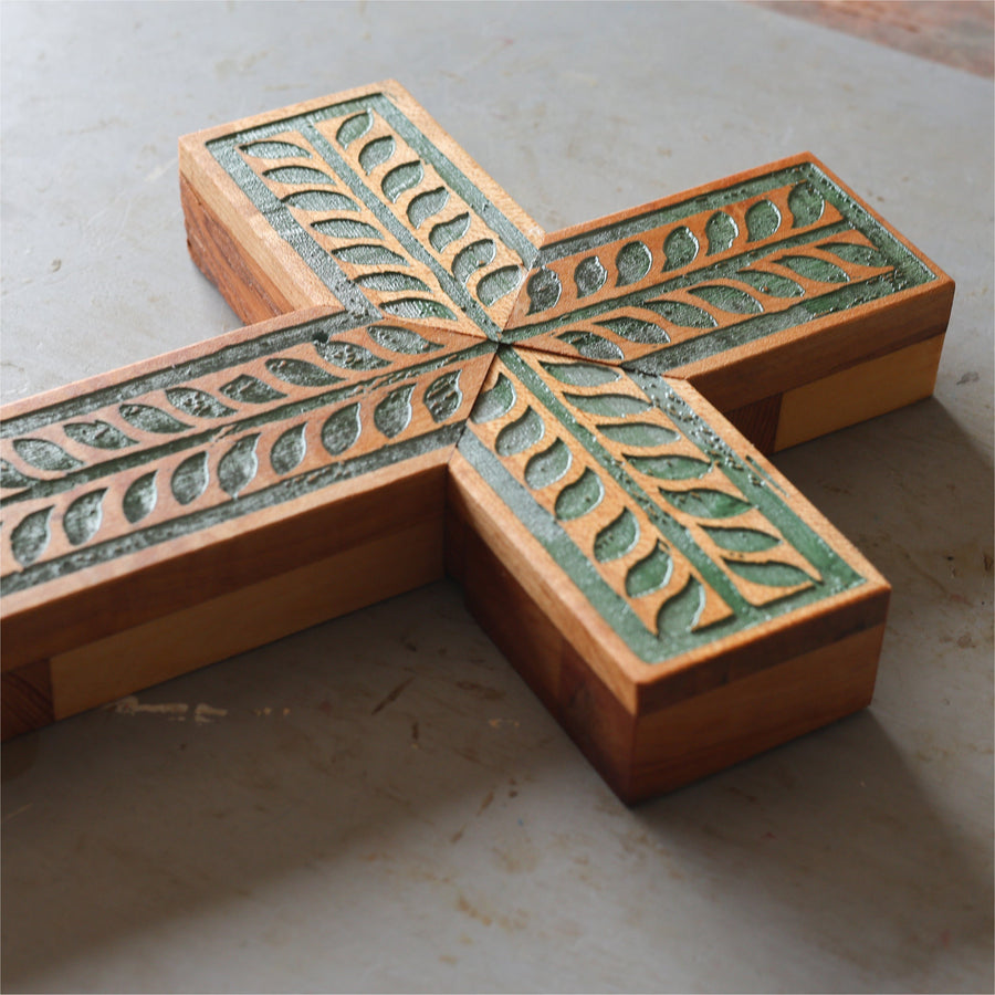 Piano wood cross engraved and painted with a turquoise vine illustration.