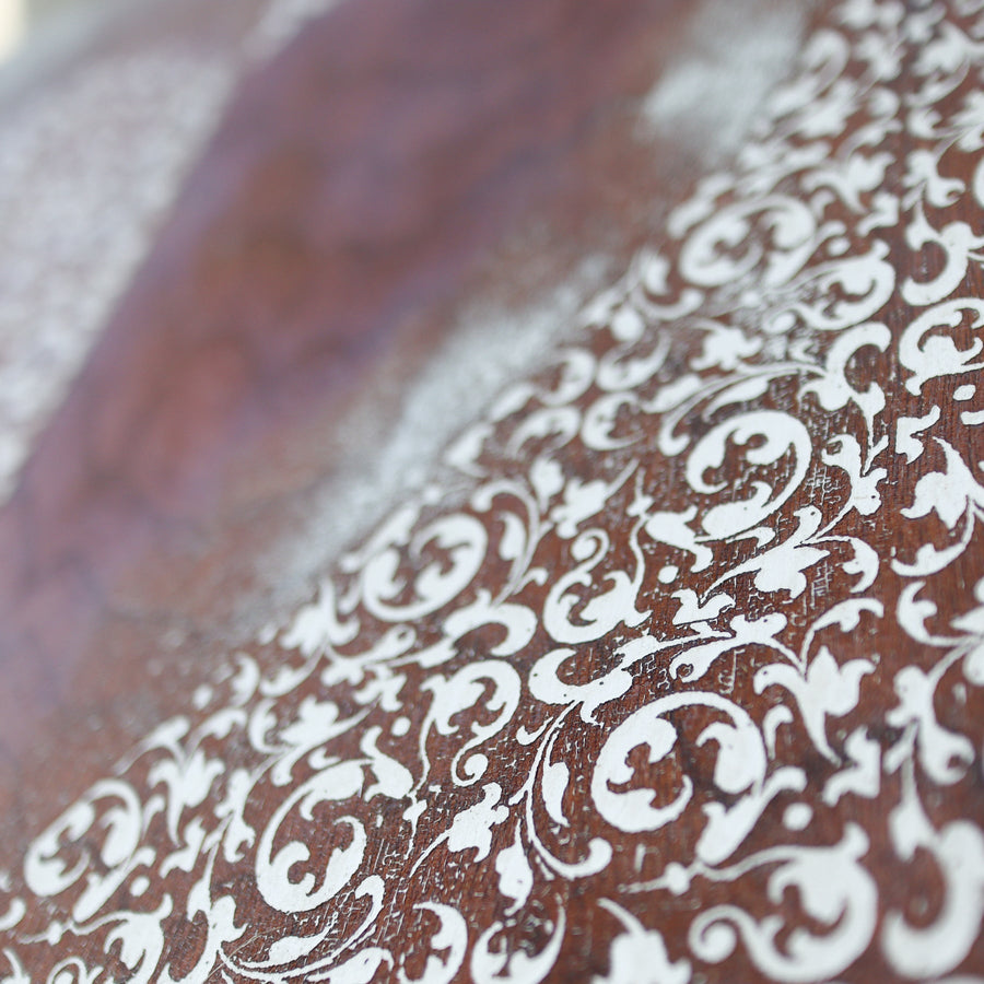 Heart of Filigree art print with a pale ornamental heart against brown wood imagery.