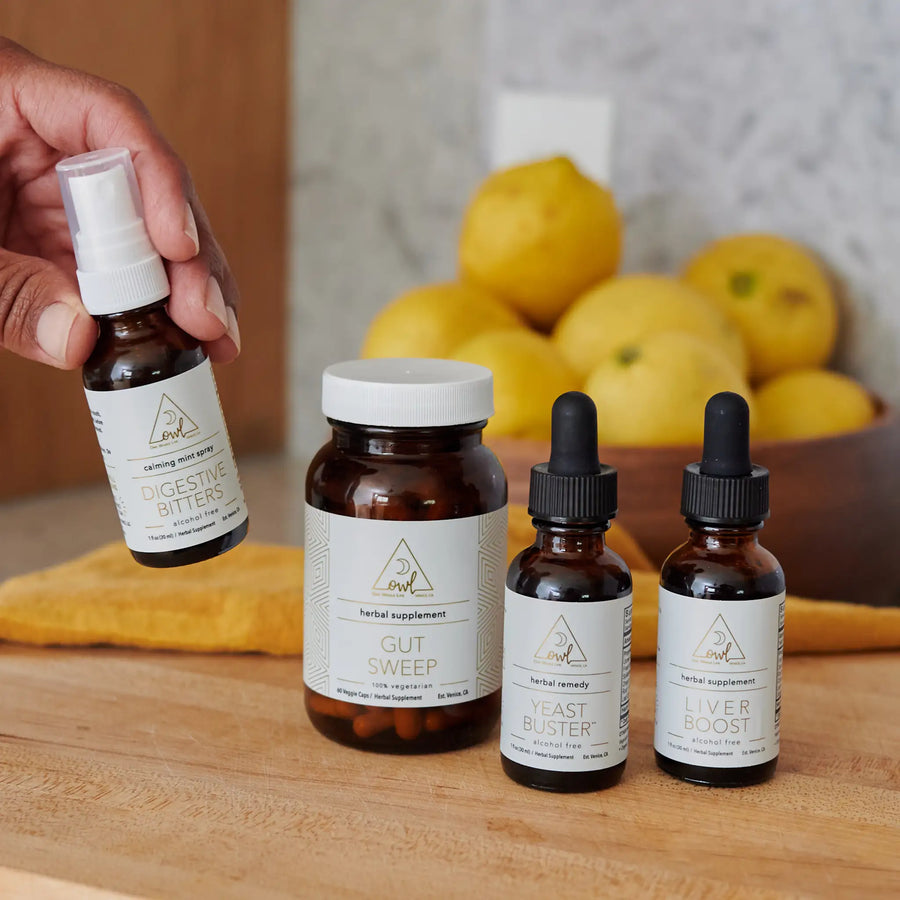 Four OWL supplement bottles arranged with lemons