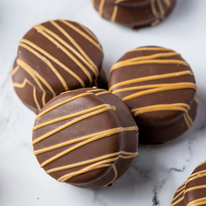 Reese’s cup-stuffed milk chocolate Oreo cookies with a contrasting drizzle