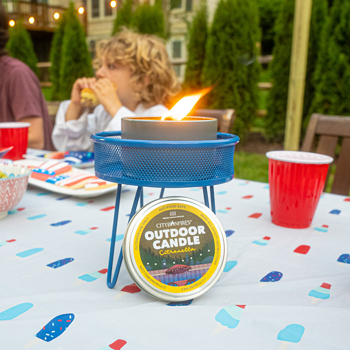 Citronella candle and lid on an outdoor party table