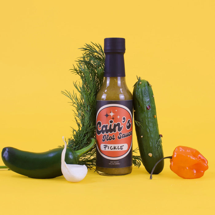 Dill pickle hot sauce bottle with jalapeño and habanero ingredients pictured
