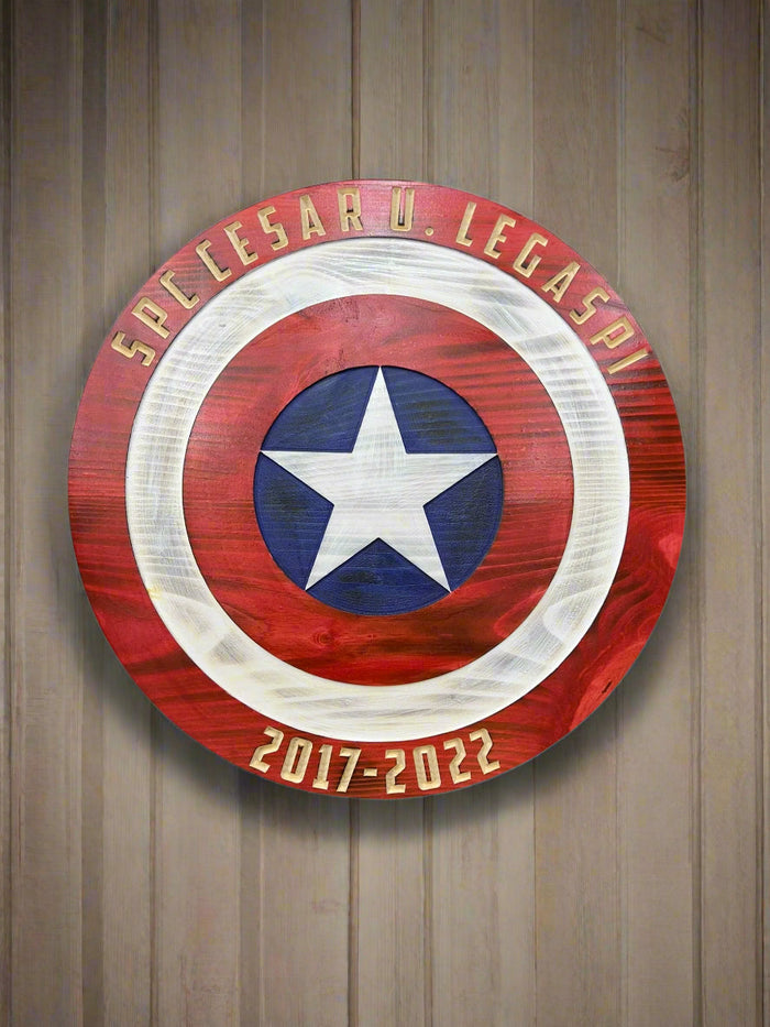 Personalized star-and-ring wooden shield mounted on a wall