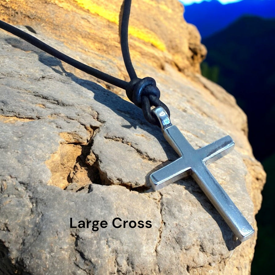Large Classic Cross pendant on cord resting on rock