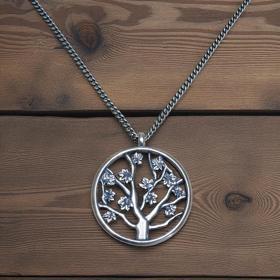 Large Tree of Life pendant and chain against wood