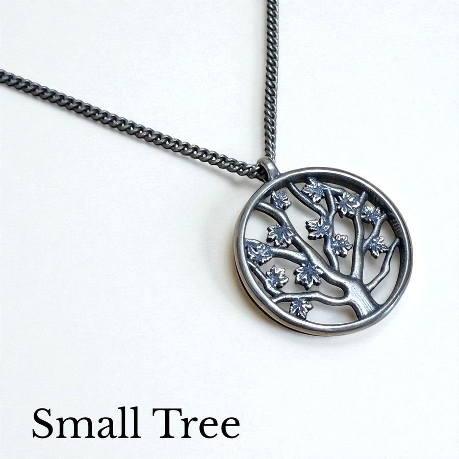 Small Tree of Life pendant on chain against white