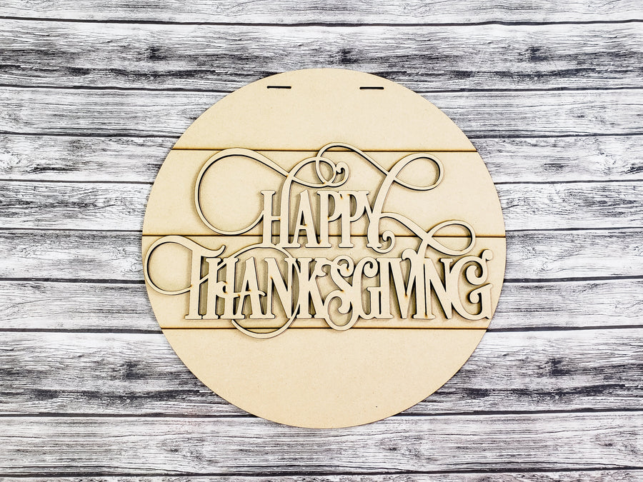 Unfinished Happy Thanksgiving lettering on a round faux-shiplap backer