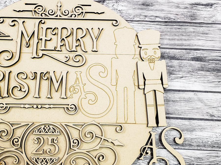 Close-up of the unfinished nutcracker figure and Christmas lettering