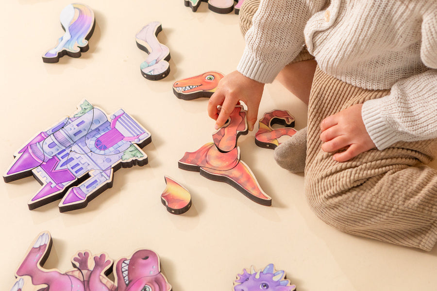 Children assembling small dinosaur-themed magnetic wooden puzzles