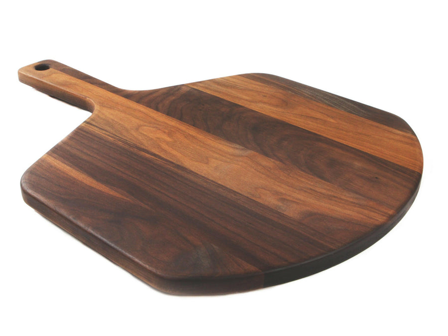 Walnut pizza peel with a broad rounded paddle and built-in handle