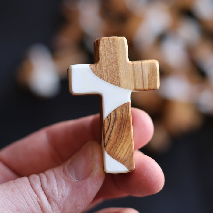Olive wood pocket crosses with contrasting white resin sections.