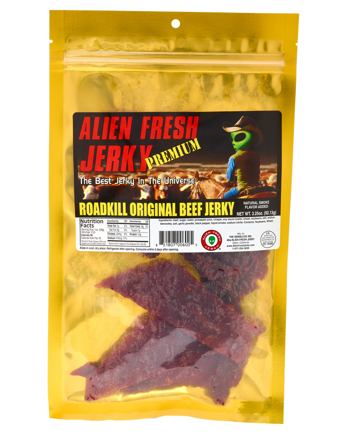 Alien Fresh Jerky Roadkill Original beef jerky in a yellow 3.25 oz resealable bag with an alien cowboy label